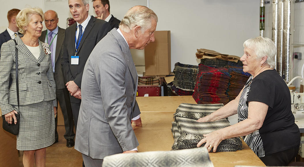 Kevin Cockerham, Production Manager of Abraham Moon and Sons is pictured above behind Prince Charles discussing wool at a Campaign for Wool event in Leeds